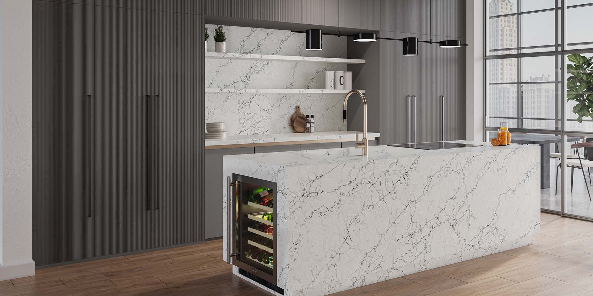 A wrapped marble-look quartz kitchen island pops against sleek charcoal, floor-to-ceiling cabinetry.