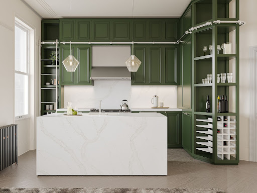 Green kitchen cabinets pop against a quartz-wrapped kitchen island with subtle veining.