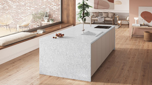A luxurious kitchen island features waterfall edges in a medium marble-look quartz.