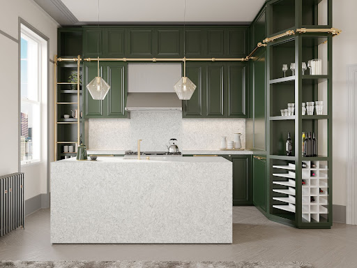 Deep green cabinets pop agains a light, veined quartz-wrapped island and backsplash.