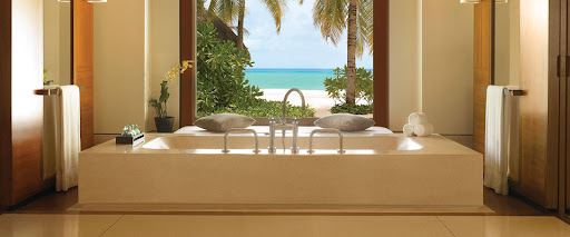 A Quantra quartz soaking tub sits in front of a panoramic ocean view.