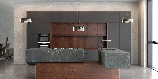 a modern kitchen features cherry cabinets and rich charcoal quartz countertops.